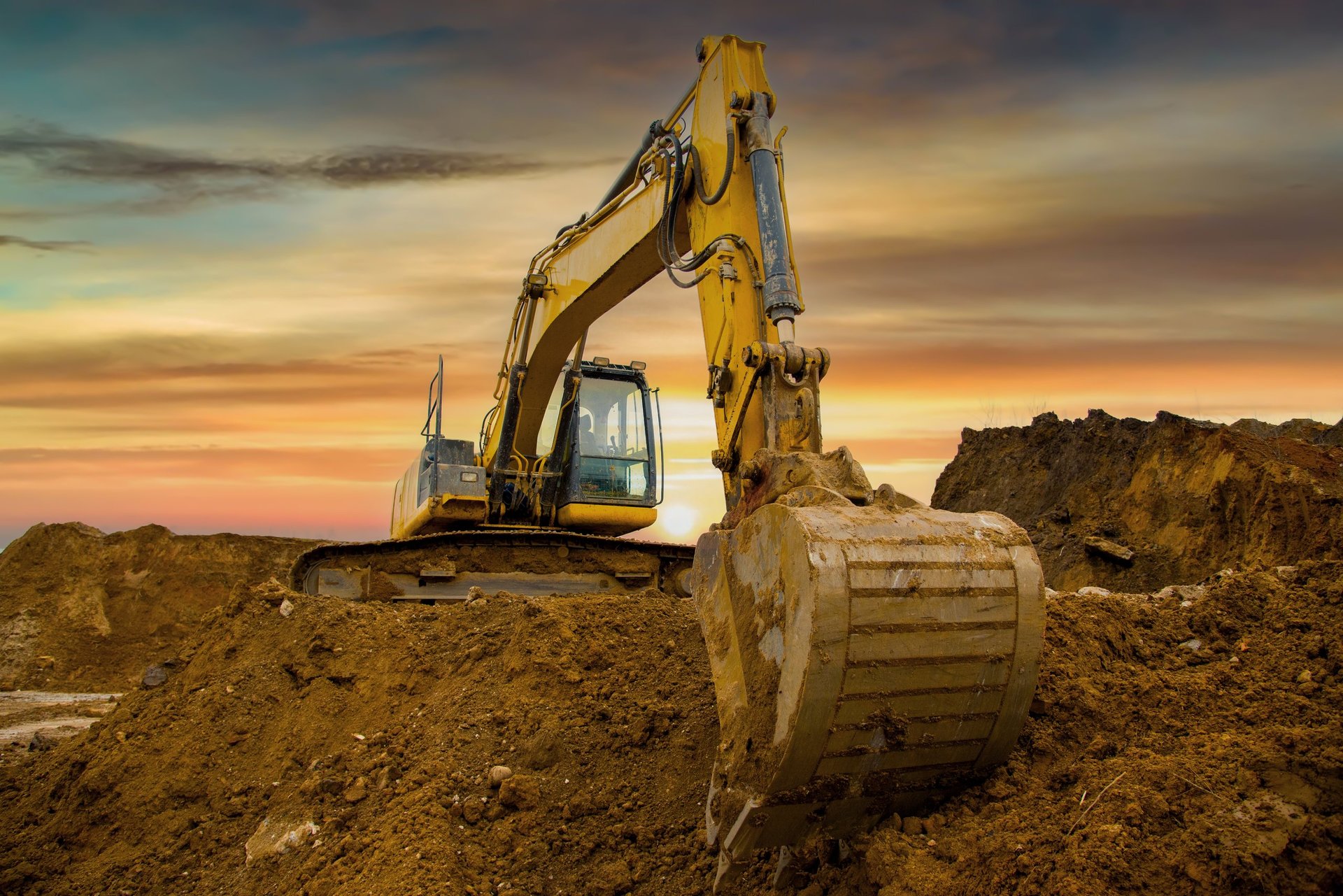 Excavator on sunset construction site